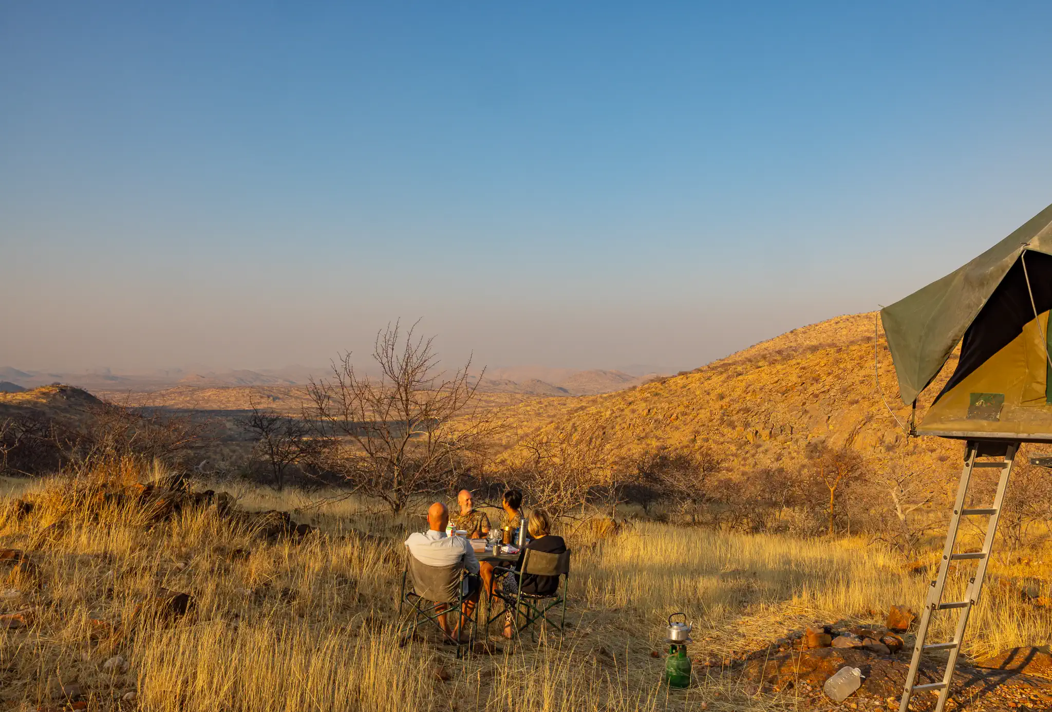 Guests enjoying breakfast at a remote campsite during a private guided safari in Namibia.