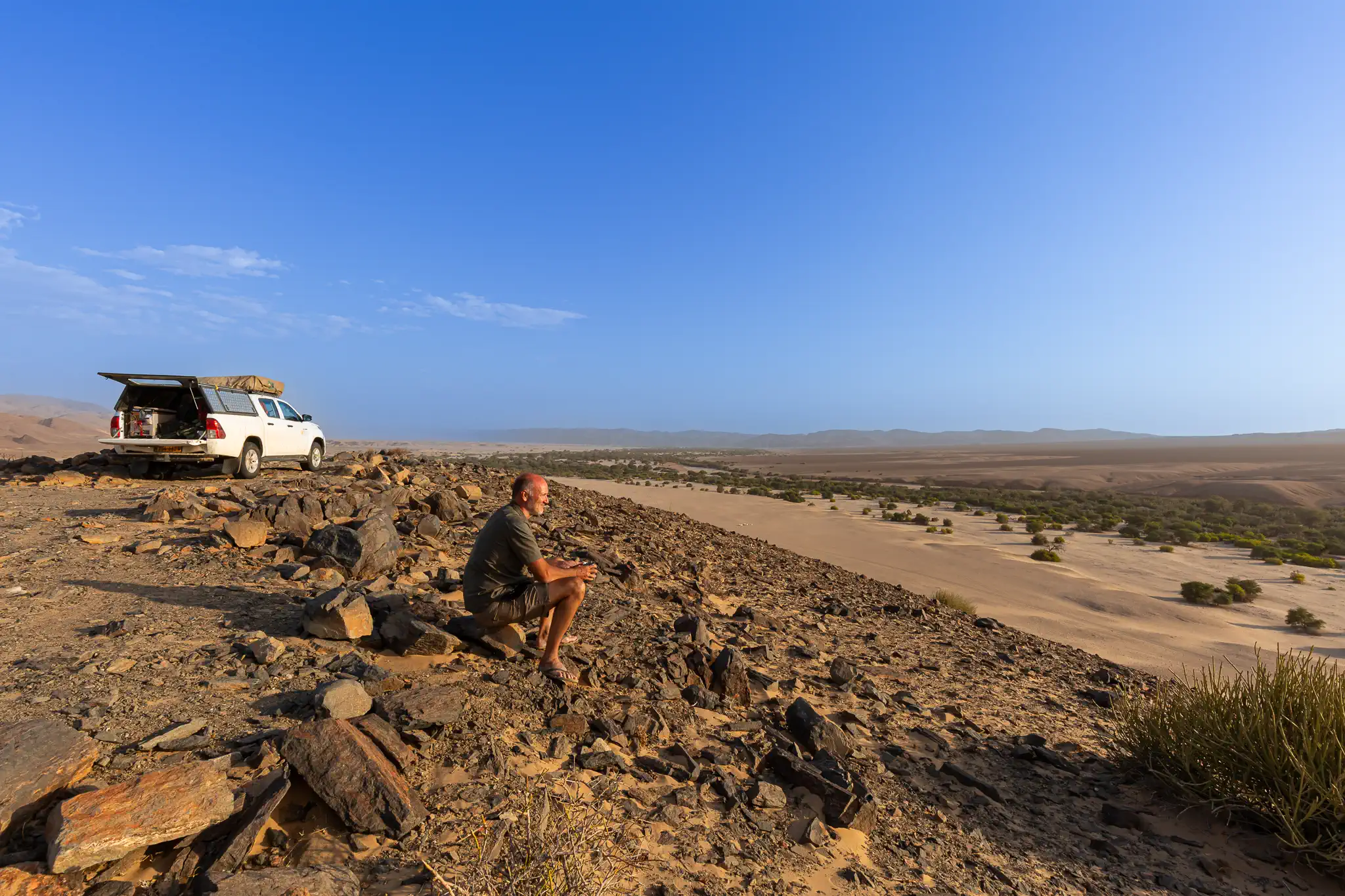 Private guide of a Namibia safari expedition overlooking the Namib Desert landscape